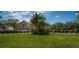 A beautiful clubhouse with manicured lawn and golf carts on display on a partly cloudy day at 29447 Schinnecock Hills Ln, San Antonio, FL 33576