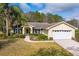 Charming single-story home with a well-manicured lawn and lush landscaping at 29447 Schinnecock Hills Ln, San Antonio, FL 33576