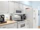 Modern kitchen featuring white appliances and cabinetry, complemented by sleek countertops at 29447 Schinnecock Hills Ln, San Antonio, FL 33576