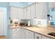 Bright kitchen featuring white cabinetry, countertops, and stainless steel appliances at 29447 Schinnecock Hills Ln, San Antonio, FL 33576