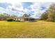 Spacious backyard featuring a screened-in patio, perfect for outdoor relaxation and entertaining at 29447 Schinnecock Hills Ln, San Antonio, FL 33576