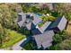 Aerial view of an estate featuring a stone home, a swimming pool, and mature landscaping at 3005 S Miller Rd, Valrico, FL 33596