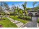 Expansive backyard with lush lawn, stone pathway, and outdoor dining area for relaxation and entertaining at 3005 S Miller Rd, Valrico, FL 33596