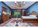 This bedroom features blue walls, a large decorative rug, and natural light from the window at 3005 S Miller Rd, Valrico, FL 33596