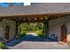 Covered entrance way featuring stone walls, wood accents, a gravel base, and outdoor seating at 3005 S Miller Rd, Valrico, FL 33596