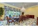 Elegant dining room featuring a chandelier, large table, and views of outdoor pool at 3005 S Miller Rd, Valrico, FL 33596