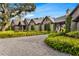 An estate home featuring stone facade, timber accents, meticulous landscaping, and a gravel drive at 3005 S Miller Rd, Valrico, FL 33596