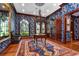 Beautiful foyer featuring elegant wallpaper, hardwood flooring, and an ornate chandelier at 3005 S Miller Rd, Valrico, FL 33596