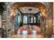 Grand foyer with stone archway, ornate details, hardwood floors, and elegant chandelier at 3005 S Miller Rd, Valrico, FL 33596