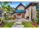 Charming stone home entrance with a blue awning and a well-manicured landscape at 3005 S Miller Rd, Valrico, FL 33596