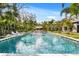 Relaxing pool surrounded by palm trees and lounge chairs creating a tranquil backyard oasis at 3005 S Miller Rd, Valrico, FL 33596