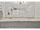 Beautiful bathroom featuring double sinks with granite countertops and gray cabinetry at 3213 W Cass St, Tampa, FL 33609