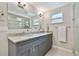 Beautiful bathroom featuring double sinks with granite countertops and a glass-enclosed shower at 3213 W Cass St, Tampa, FL 33609