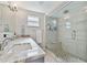 Modern bathroom featuring a marble countertop, glass-enclosed shower, and stylish fixtures at 3213 W Cass St, Tampa, FL 33609