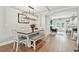 Dining area with modern table set, chandelier, hardwood floors, and access to outdoor area at 3213 W Cass St, Tampa, FL 33609