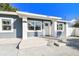 Close up of the renovated home's front entrance with new concrete steps and walkway at 3213 W Cass St, Tampa, FL 33609