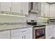 Modern kitchen showcasing stainless steel appliances, white cabinetry, and light countertops at 3213 W Cass St, Tampa, FL 33609