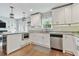 Modern kitchen with stainless steel appliances, granite countertops, and hardwood floors at 3213 W Cass St, Tampa, FL 33609