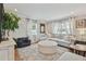 Bright living room featuring hardwood floors, a comfortable sofa, and a neutral color palette at 3213 W Cass St, Tampa, FL 33609