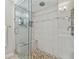 Beautiful shower with a glass enclosure, tile accents, and a built-in bench at 3213 W Cass St, Tampa, FL 33609