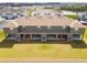 Aerial view of a gray townhouse complex with a lake nearby at 33065 Major Oak Dr, Wesley Chapel, FL 33545