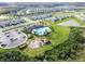 Aerial view of community pool, playground, and surrounding residential neighborhood at 33065 Major Oak Dr, Wesley Chapel, FL 33545