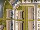 Aerial view of multiple townhomes with a pond in the community, showcasing the layout and neighborhood's design at 33065 Major Oak Dr, Wesley Chapel, FL 33545