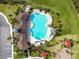 Overhead view of a community pool, playground, clubhouse and beautiful landscaping at 33065 Major Oak Dr, Wesley Chapel, FL 33545