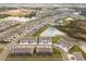 Wide aerial view of a residential neighborhood with homes, lakes, and green spaces at 33065 Major Oak Dr, Wesley Chapel, FL 33545