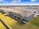 Aerial view of townhouse complex with gray exteriors and brown roofs at 33065 Major Oak Dr, Wesley Chapel, FL 33545