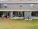 Back view of townhouse with covered patios and lawn at 33065 Major Oak Dr, Wesley Chapel, FL 33545