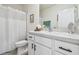 Clean bathroom featuring a vanity with modern fixtures, white cabinets, and a shower with white curtain at 33065 Major Oak Dr, Wesley Chapel, FL 33545