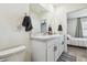 Bathroom featuring double sinks, white cabinetry, and modern fixtures, with a bedroom view at 33065 Major Oak Dr, Wesley Chapel, FL 33545