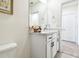 Well-lit bathroom featuring white cabinets, modern fixtures, and a large mirror at 33065 Major Oak Dr, Wesley Chapel, FL 33545