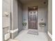 A welcoming front entryway with a dark front door and decorative flower boxes on either side at 33065 Major Oak Dr, Wesley Chapel, FL 33545