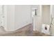 Hallway with stairs leading down, neutral carpet, and a view into a bedroom at 33065 Major Oak Dr, Wesley Chapel, FL 33545