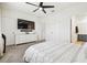 Spacious main bedroom with neutral carpet, a ceiling fan, and a view to a bathroom at 33065 Major Oak Dr, Wesley Chapel, FL 33545