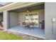 Relaxing covered patio with ceiling fan, table with chairs, and barbecue grill at 33065 Major Oak Dr, Wesley Chapel, FL 33545