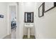 Stylish powder room featuring pedestal sink, framed mirror, and elegant decor at 33065 Major Oak Dr, Wesley Chapel, FL 33545