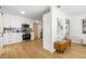 Modern white kitchen featuring stainless steel appliances, stylish backsplash, and wood flooring at 3412 71St N St, St Petersburg, FL 33710