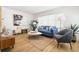 Bright and airy living room with a blue sofa, modern decor, and large windows at 3412 71St N St, St Petersburg, FL 33710