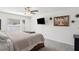 Serene bedroom with mounted TV, ceiling fan, and natural light at 36642 Garden Wall Way, Zephyrhills, FL 33541