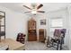 Well-lit bedroom with a ceiling fan, a window, and stylish vintage furniture at 36642 Garden Wall Way, Zephyrhills, FL 33541