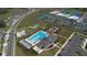 Aerial of a community pool, tennis courts, playground, and community center, offering many opportunities at 36642 Garden Wall Way, Zephyrhills, FL 33541