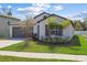 Beautiful one-story home featuring manicured landscaping, gray trim, and an attached two-car garage at 36642 Garden Wall Way, Zephyrhills, FL 33541