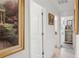 Bright hallway showcases elegant artwork, neutral colors, and access to other rooms at 36642 Garden Wall Way, Zephyrhills, FL 33541