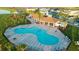 Aerial view of a community pool with outdoor seating and tables, ideal for relaxing and socializing at 36642 Garden Wall Way, Zephyrhills, FL 33541