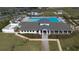 An aerial view of a resort style community pool and recreation center surrounded by lush green lawns at 36642 Garden Wall Way, Zephyrhills, FL 33541