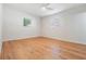 Bright bedroom featuring hardwood floors, natural light from two windows, and a ceiling fan at 3908 W Laurel St, Tampa, FL 33607