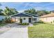 Charming one-story home boasts fresh landscaping, a carport, and a freshly painted exterior at 3908 W Laurel St, Tampa, FL 33607